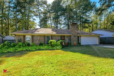 Single story home with a garage and a front lawn