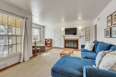 Living area featuring wood finished floors and a brick fireplace