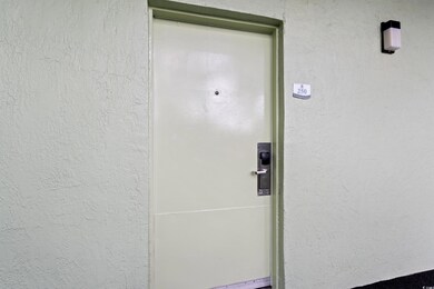 Entrance to property with stucco siding
