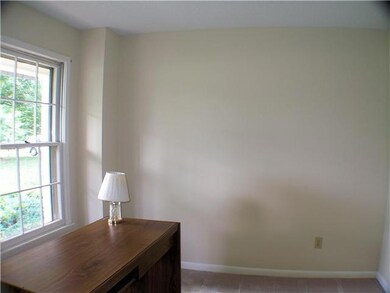 Home office has carpet and is off the foyer.