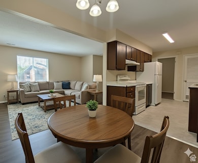 Dining room featuring light wood-style floors and a chandelier