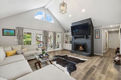 Large Living Room with Vaulted Ceilings, Gas Fireplace, Custom Built-Ins and a TON of Natural Light!