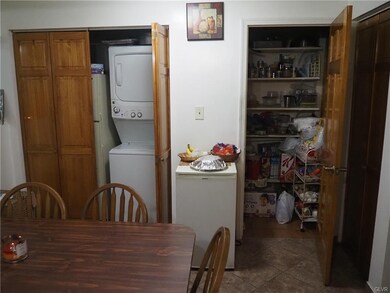 Kitchen with washer/dryer & pantry.