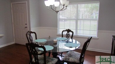 Formal dining room has new chandelier and wood flo