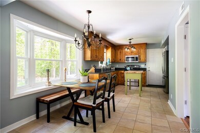 Tiled eat in kitchen, granite, stainless steel app