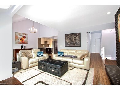Semi open floor plan shows living room, front entr