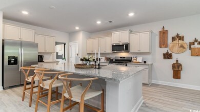 Kitchen with light stone counters, stainless steel