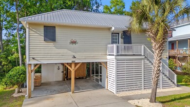 Coastal inspired home featuring a carport, drivewa