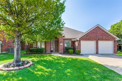 View of front of home with a front lawn and a garage