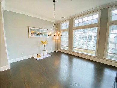 Unfurnished dining area featuring baseboards, a chandelier, crown molding, and dark wood-style flooring