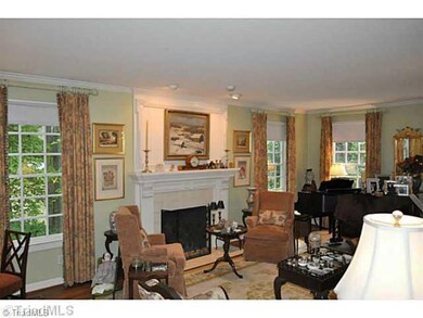 Living Room. This gracious living room with its hardwood floor and elegant masonry fireplace is so inviting.