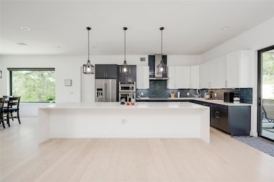 Kitchen featuring stainless steel appliances, lig