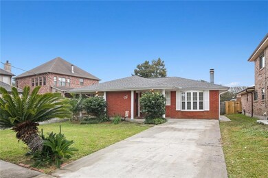 Front view of house. Long drive way for cars.