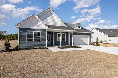 View of front of property with covered porch, a garage, and central AC unit