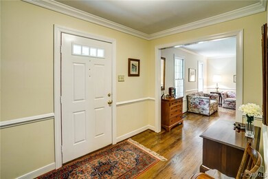 Foyer with wood floor, guest closet, and access to
