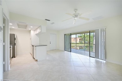 Unfurnished room featuring light tile patterned floors, a ceiling fan, recessed lighting, and attic access