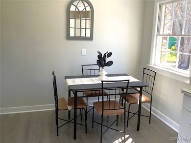 Dining room with baseboards and wood finished floo