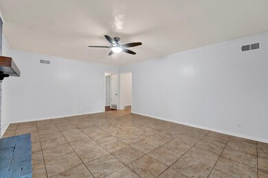 Interior space featuring ceiling fan and light til