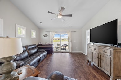 Living area featuring vaulted ceiling, a ceiling f
