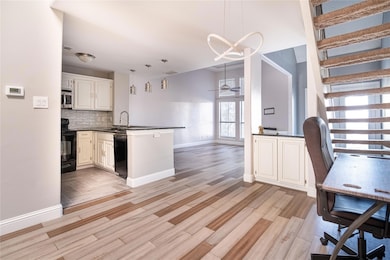 Kitchen with dark countertops, a peninsula, black 