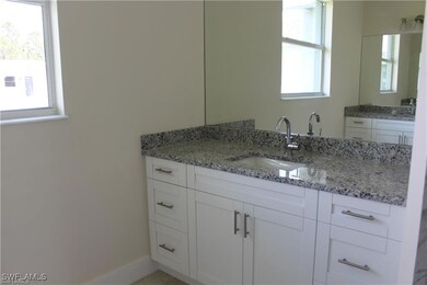 Bathroom featuring vanity and baseboards