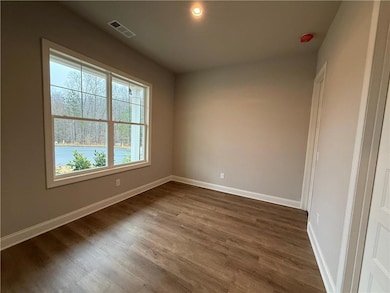 Spare room with dark wood-style flooring and recessed lighting