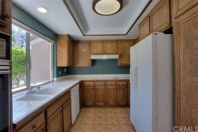 Another view of kitchen. Refrigerator, washer and 