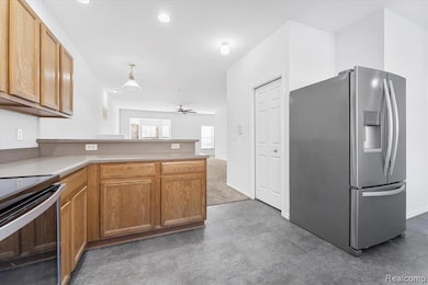 Kitchen with stainless steel appliances, light countertops, a peninsula, a ceiling fan, and recessed lighting