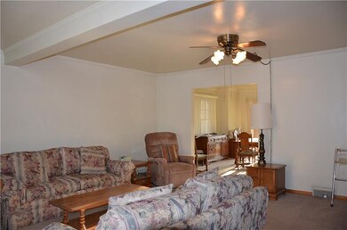 Step into a large living room with ceiling fan