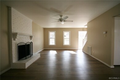 Living room with a fireplace, brick wall, ceiling