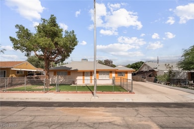 Bungalow-style home featuring a fenced front yard, driveway, and a gate