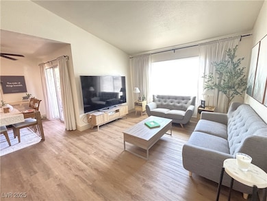 Living area with vaulted ceiling, a textured ceili