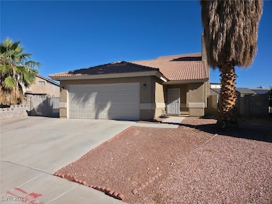 Ranch-style home featuring driveway, stucco siding, a gate, and an attached garage
