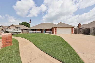 View of front of home with a porch, brick siding, driveway, a garage, and roof with shingles