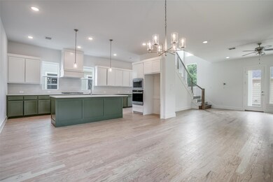 Kitchen with white cabinets, a kitchen island with
