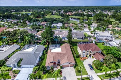 Aerial view of home with golf course and ponds in 