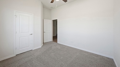 Unfurnished bedroom featuring carpet floors and a ceiling fan