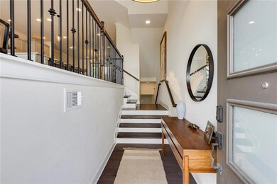 Stairs with a high ceiling, wood finished floors, and recessed lighting