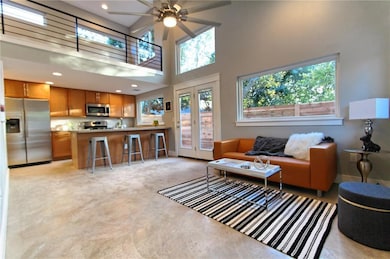 Living room with a ceiling fan, a wealth of natur