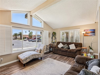 Living area featuring wood finished floors and a textured ceiling