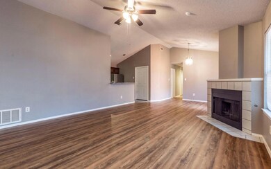 Unfurnished living room with ceiling fan, wood fi