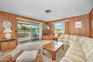 Living room with carpet and wooden walls