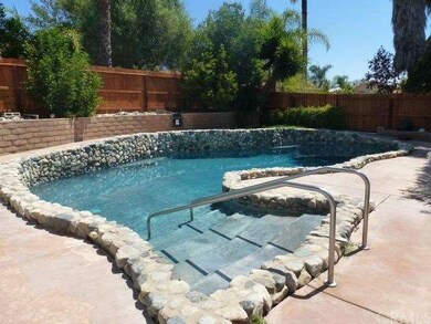 9 1/2 ft deep pool with custom rock trim. Note the