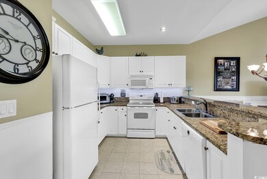 Kitchen with light tile patterned flooring, a sink