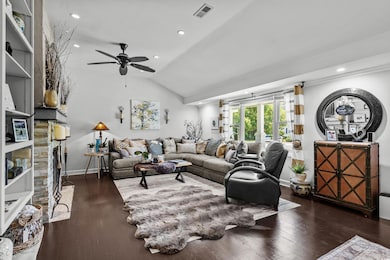 Living room with vaulted ceiling, wood finished floors, ceiling fan, recessed lighting, and baseboards