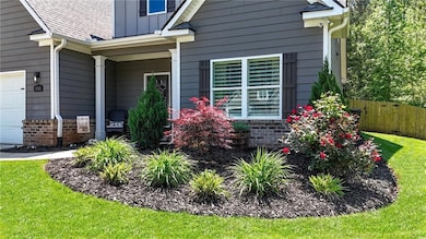 Property entrance featuring fence, board and batte