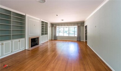Spacious living room has built-ins on either side 