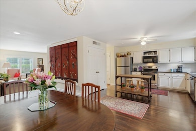 Dining area featuring dark wood-type flooring and 