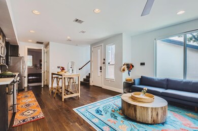 Living area featuring stairway, dark wood finishe