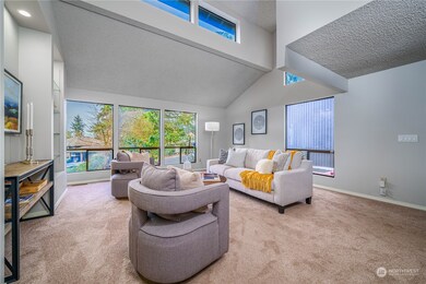 From the entry, step into an expansive living room with soaring ceilings and grand picture and clerestory windows that flood the space with natural light.
